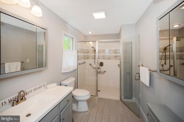 302 Gold Valley Rd, Locust Grove, VA 22508 - bathroom with a shower stall, toilet, wood finished floors, and vanity