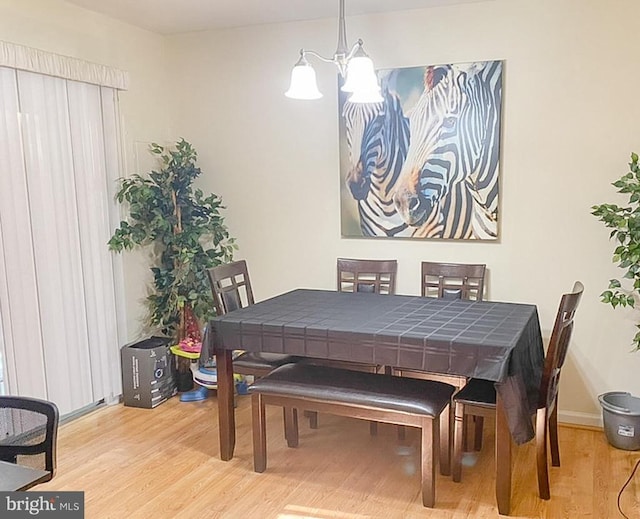 988 Towne Ln, Charlottesville, VA 22901 - dining space with wood finished floors, a chandelier, and baseboards