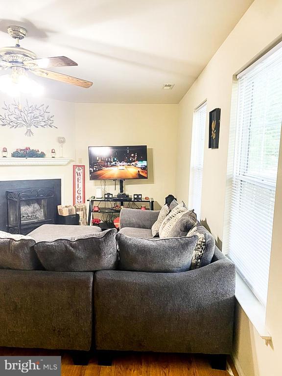988 Towne Ln, Charlottesville, VA 22901 - living area with a ceiling fan, wood finished floors, and a fireplace