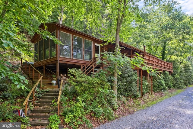 view of property exterior featuring a sunroom