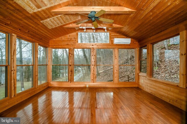 unfurnished sunroom with vaulted ceiling, plenty of natural light, a wall mounted air conditioner, and wooden ceiling