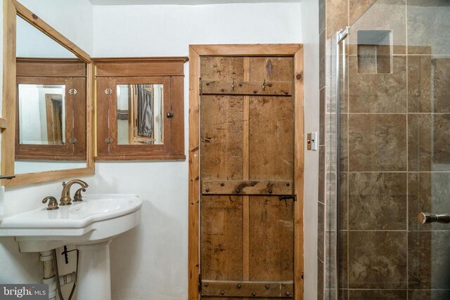 bathroom with a shower with shower door