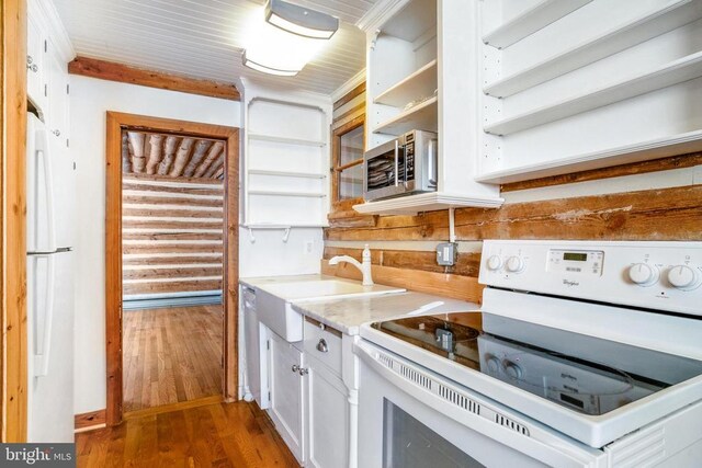 kitchen featuring dark hardwood / wood-style floors, sink, white cabinets, and white appliances