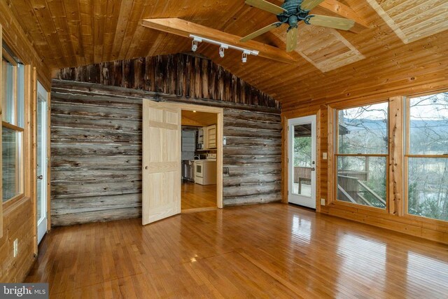 interior space featuring wood ceiling, vaulted ceiling with beams, wooden walls, and hardwood / wood-style flooring