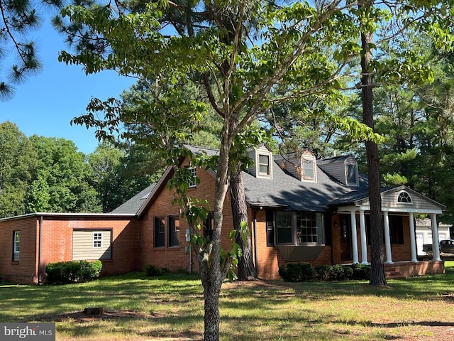 9872 Red Hill Rd, Spotsylvania, VA 22553 - cape cod house featuring brick siding, a front lawn, a porch, and a shingled roof