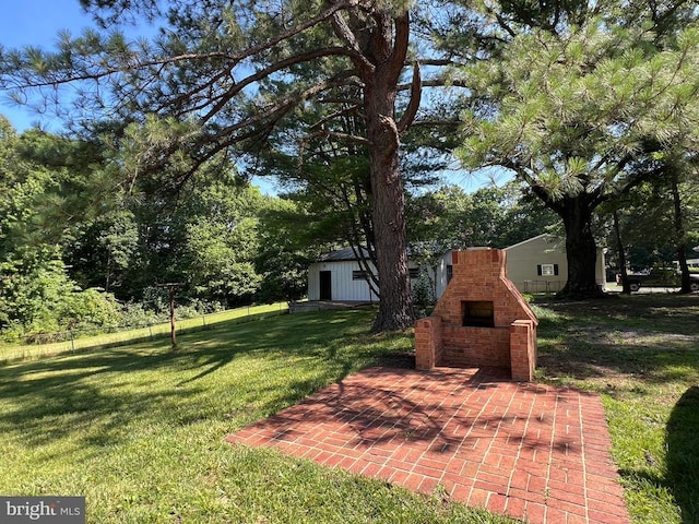 9872 Red Hill Rd, Spotsylvania, VA 22553 - view of yard featuring an outdoor brick fireplace and a patio area