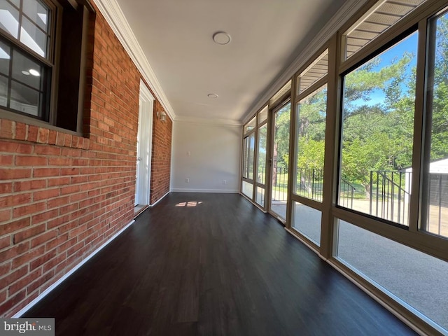 9872 Red Hill Rd, Spotsylvania, VA 22553 - unfurnished sunroom featuring brick wall, wood finished floors, and crown molding