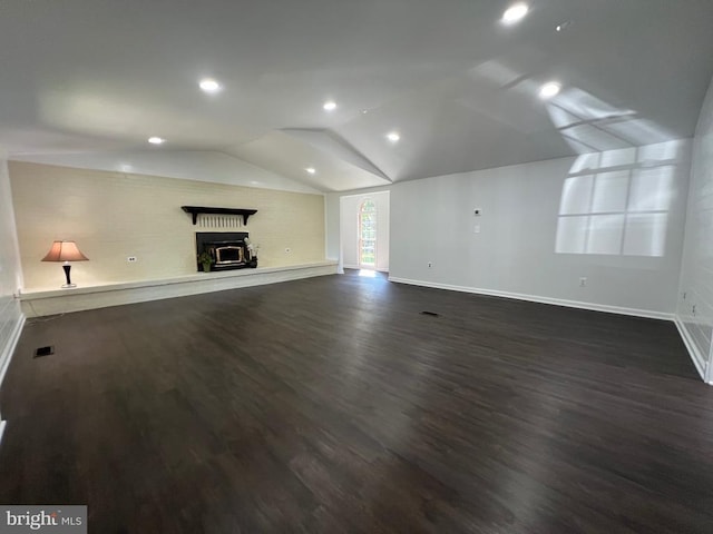 9872 Red Hill Rd, Spotsylvania, VA 22553 - unfurnished living room featuring dark wood-style floors, a fireplace with raised hearth, lofted ceiling, and recessed lighting