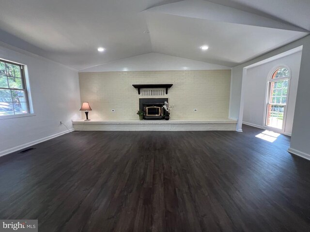 9872 Red Hill Rd, Spotsylvania, VA 22553 - unfurnished living room with vaulted ceiling, wood finished floors, a fireplace, and brick wall