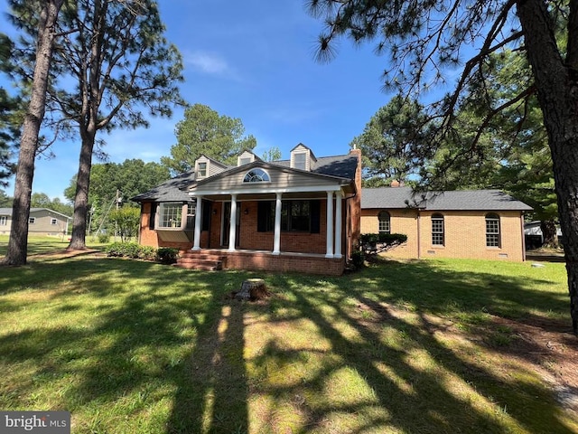 9872 Red Hill Rd, Spotsylvania, VA 22553 - view of front of house featuring brick siding, covered porch, and a front yard
