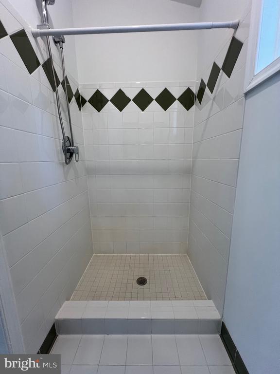 9872 Red Hill Rd, Spotsylvania, VA 22553 - full bathroom with a tile shower and tile patterned flooring