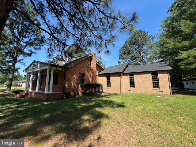9872 Red Hill Rd, Spotsylvania, VA 22553 - view of side of home featuring a porch, brick siding, a yard, and crawl space