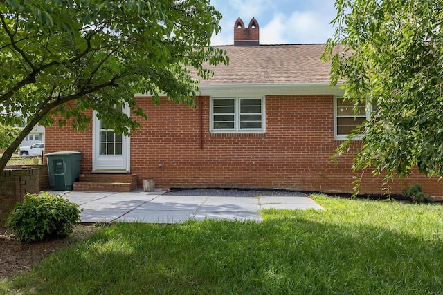871 Kent Rd, Waynesboro, VA 22980 - back of house with entry steps, a chimney, a patio, brick siding, and a lawn