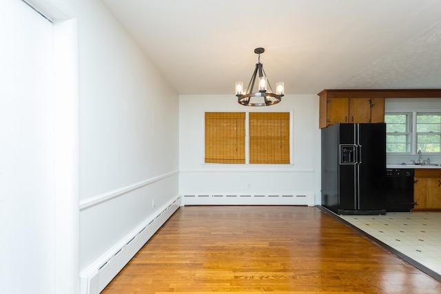 871 Kent Rd, Waynesboro, VA 22980 - unfurnished dining area featuring a baseboard radiator, a chandelier, light wood finished floors, and baseboard heating
