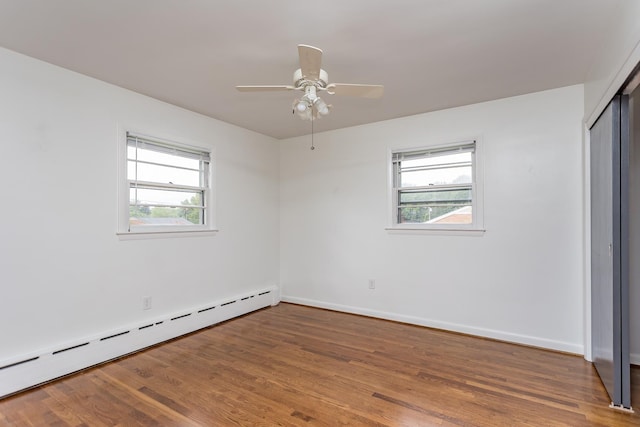 871 Kent Rd, Waynesboro, VA 22980 - unfurnished bedroom with a baseboard heating unit, multiple windows, and wood finished floors