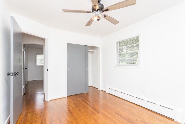 871 Kent Rd, Waynesboro, VA 22980 - unfurnished bedroom featuring a baseboard radiator, light wood finished floors, a closet, and a ceiling fan