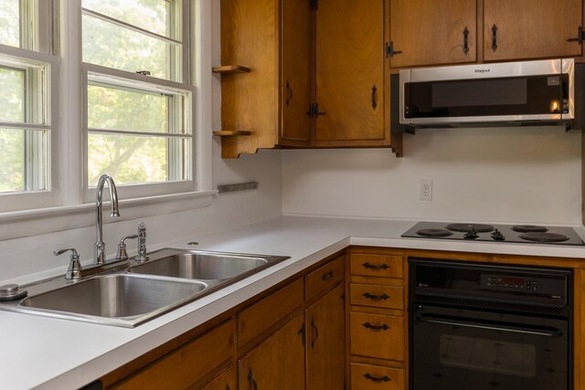 871 Kent Rd, Waynesboro, VA 22980 - kitchen with black appliances, light countertops, plenty of natural light, and brown cabinetry