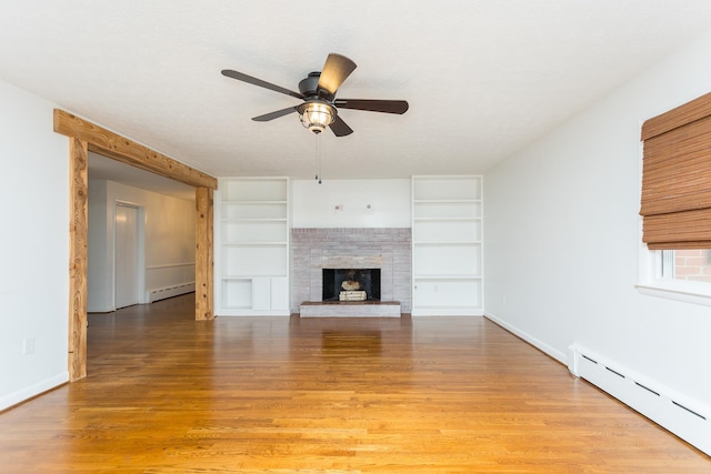 871 Kent Rd, Waynesboro, VA 22980 - unfurnished living room featuring a baseboard radiator, ceiling fan, built in features, light wood-style floors, and a fireplace with raised hearth