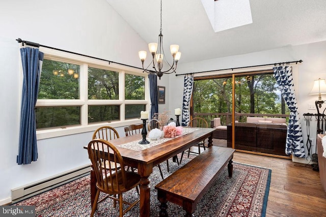 589 Pedlars Edge Dr, Roseland, VA 22967 - dining space featuring a chandelier, a baseboard heating unit, wood finished floors, a skylight, and high vaulted ceiling