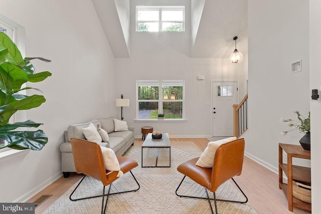 5831 Stubbs Bridge Rd, Mineral, VA 23117 - living room featuring high vaulted ceiling, light wood-type flooring, plenty of natural light, stairway, and baseboards