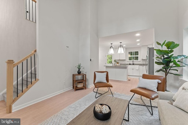 5831 Stubbs Bridge Rd, Mineral, VA 23117 - living area featuring a towering ceiling, light wood-type flooring, baseboards, stairs, and recessed lighting
