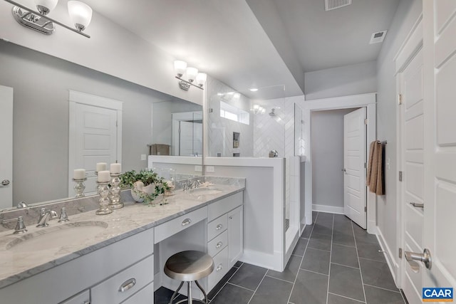 full bath with visible vents, a walk in shower, and a sink