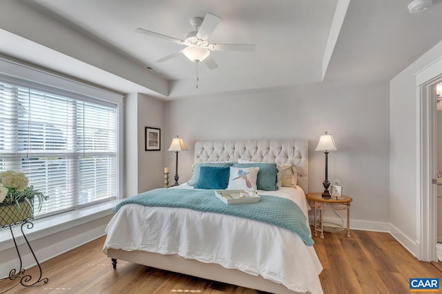 bedroom featuring baseboards, ceiling fan, and wood finished floors