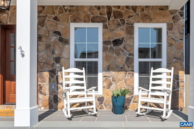 doorway to property featuring stone siding