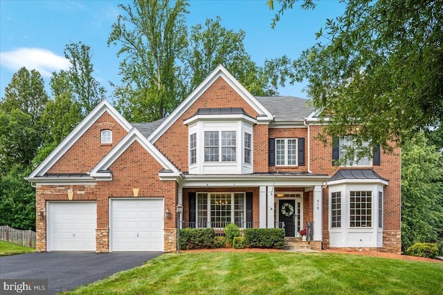 519 Cardinal Ln, Warrenton, VA 20186 - view of front of property with asphalt driveway, covered porch, a garage, and brick siding