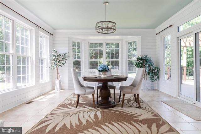 519 Cardinal Ln, Warrenton, VA 20186 - sunroom featuring tile patterned floors, ornamental molding, a chandelier, and wood walls