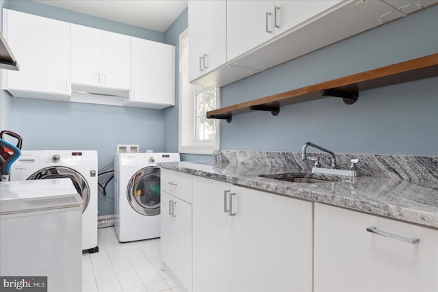 519 Cardinal Ln, Warrenton, VA 20186 - washroom with independent washer and dryer, cabinet space, and light tile patterned flooring
