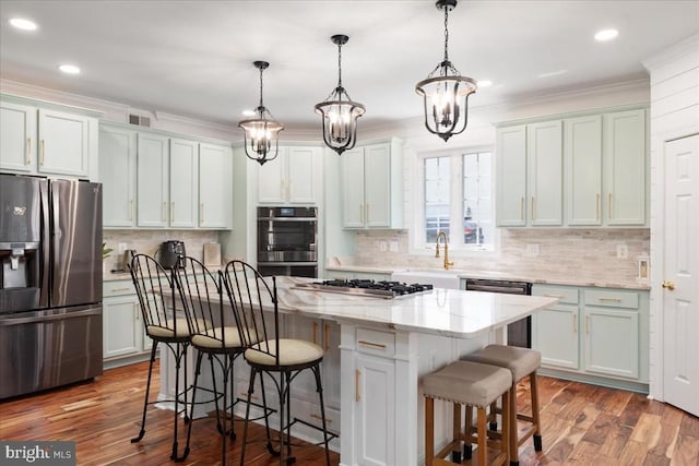 519 Cardinal Ln, Warrenton, VA 20186 - kitchen with appliances with stainless steel finishes, a center island, a kitchen bar, decorative backsplash, and ornamental molding
