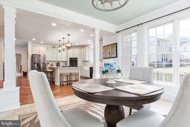 519 Cardinal Ln, Warrenton, VA 20186 - dining area featuring decorative columns, a chandelier, plenty of natural light, ornamental molding, and light tile patterned floors