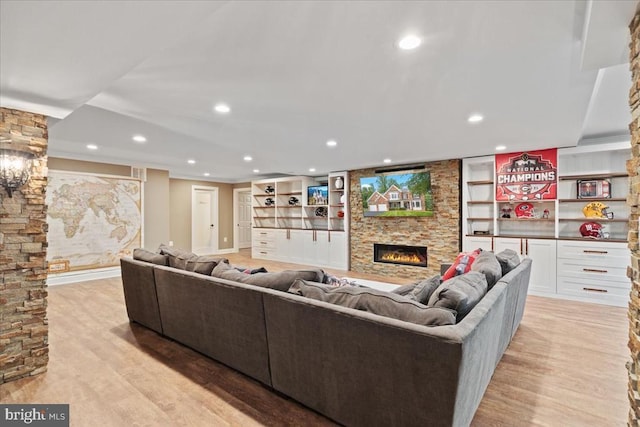 519 Cardinal Ln, Warrenton, VA 20186 - living room featuring a stone fireplace, light wood-type flooring, recessed lighting, and built in shelves