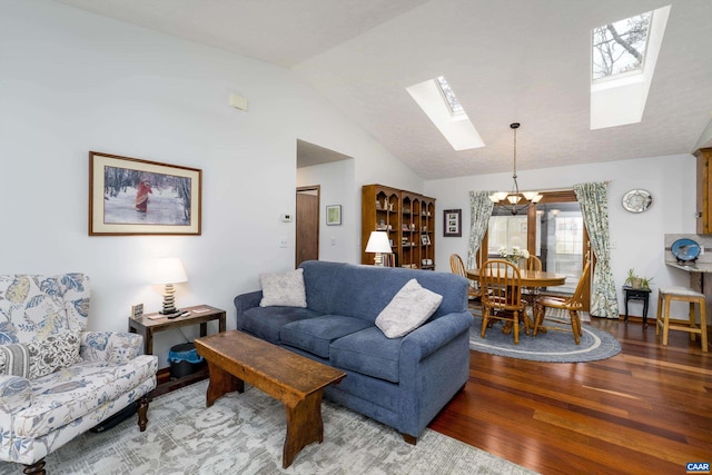 609 Jefferson Dr, Palmyra, VA 22963 - living room with a chandelier, wood finished floors, and vaulted ceiling with skylight