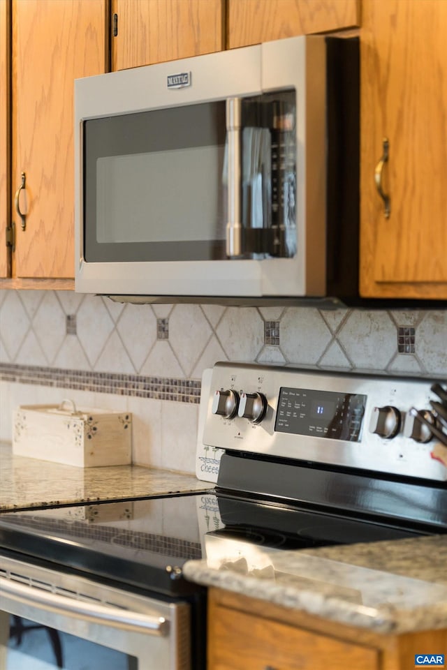609 Jefferson Dr, Palmyra, VA 22963 - kitchen featuring backsplash, brown cabinets, light countertops, and appliances with stainless steel finishes