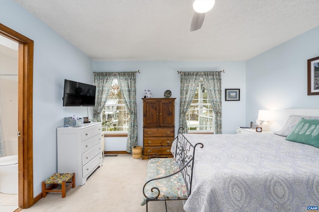 609 Jefferson Dr, Palmyra, VA 22963 - bedroom featuring a ceiling fan, ensuite bathroom, light carpet, and a textured ceiling