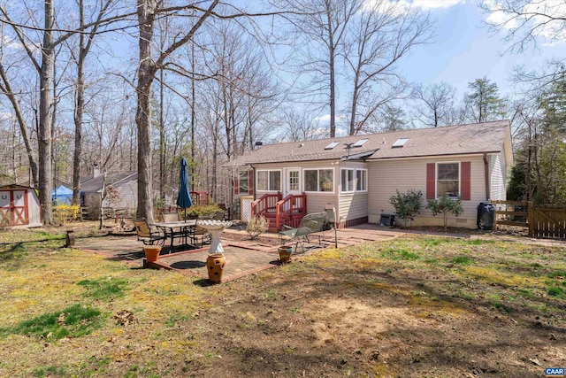 609 Jefferson Dr, Palmyra, VA 22963 - rear view of property with fence, crawl space, a storage unit, a patio, and an outbuilding