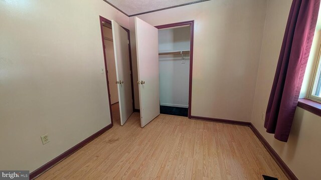 400 Laurel Dr, Madison, VA 22727 - unfurnished bedroom with light wood finished floors and a closet