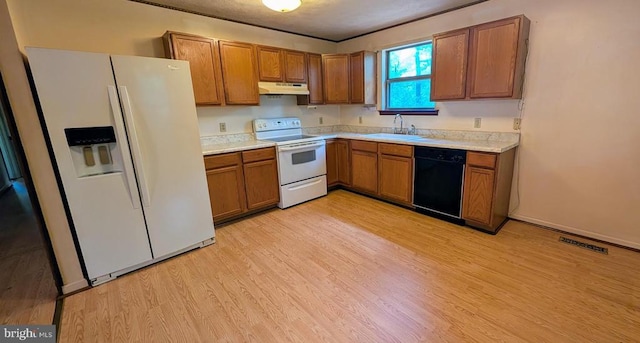 400 Laurel Dr, Madison, VA 22727 - kitchen with white appliances, under cabinet range hood, brown cabinets, light wood finished floors, and light countertops