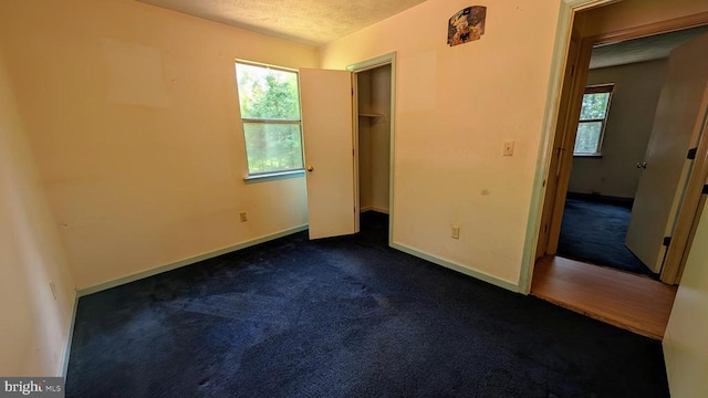 400 Laurel Dr, Madison, VA 22727 - unfurnished bedroom featuring dark carpet, a textured ceiling, and a closet