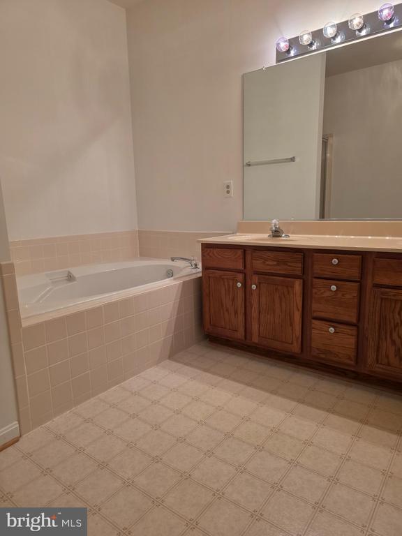 11206 Lynchburg Dr, Fredericksburg, VA 22407 - bathroom with vanity, a bath, and tile patterned floors