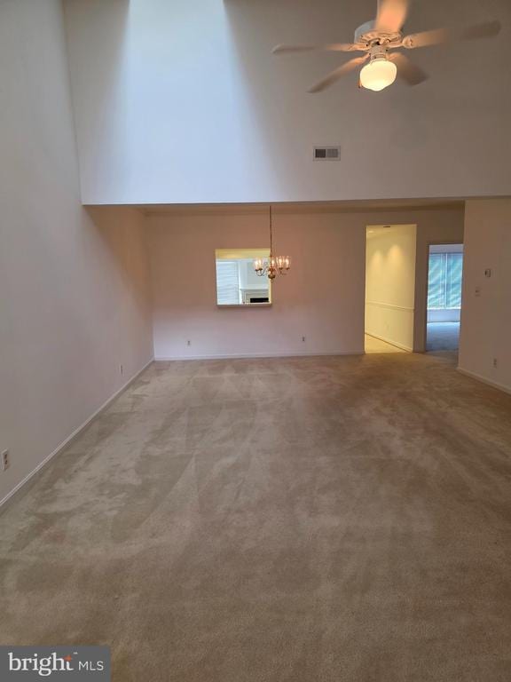 11206 Lynchburg Dr, Fredericksburg, VA 22407 - unfurnished room with light carpet, a high ceiling, a chandelier, and a ceiling fan