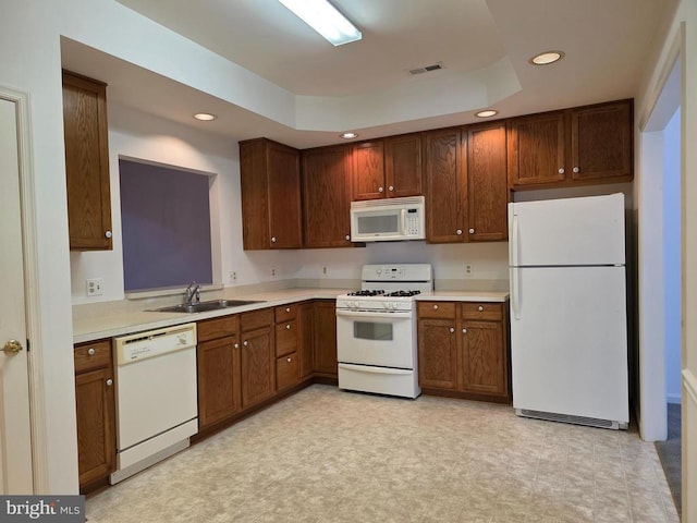 11206 Lynchburg Dr, Fredericksburg, VA 22407 - kitchen featuring white appliances, a tray ceiling, recessed lighting, light countertops, and light floors