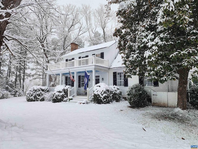 190 Perkins Rd, Kents Store, VA 23084 - snow covered back of property featuring covered porch, a chimney, and a balcony