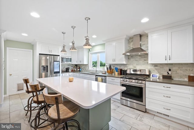 13001 Country View Ln, Amissville, VA 20106 - kitchen with wall chimney exhaust hood, appliances with stainless steel finishes, a breakfast bar area, decorative backsplash, and white cabinets