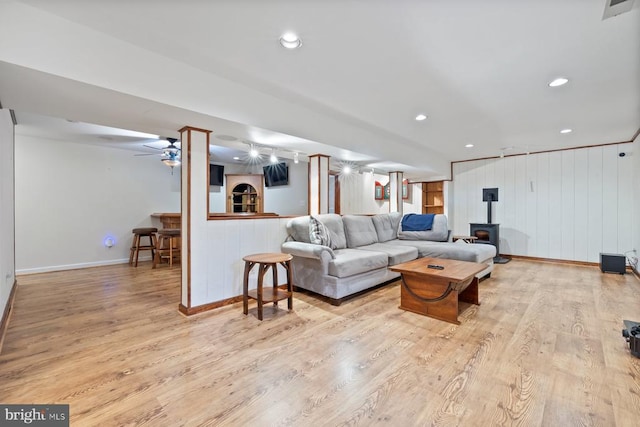 13001 Country View Ln, Amissville, VA 20106 - living area featuring a wood stove, wood finished floors, a decorative wall, and recessed lighting