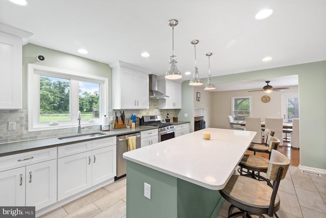 13001 Country View Ln, Amissville, VA 20106 - kitchen featuring appliances with stainless steel finishes, wall chimney range hood, a kitchen bar, backsplash, and white cabinetry