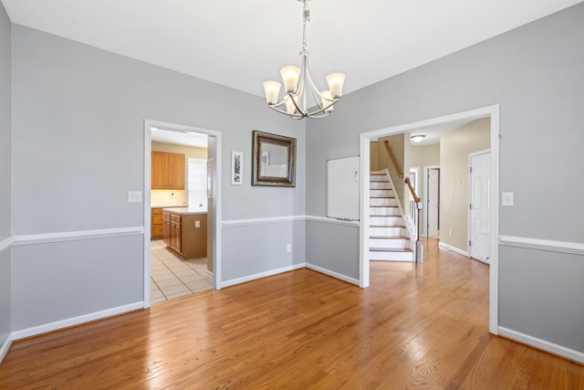 30 Sir Robin Rd, Waynesboro, VA 22980 - unfurnished dining area featuring a chandelier, stairway, light wood finished floors, and baseboards