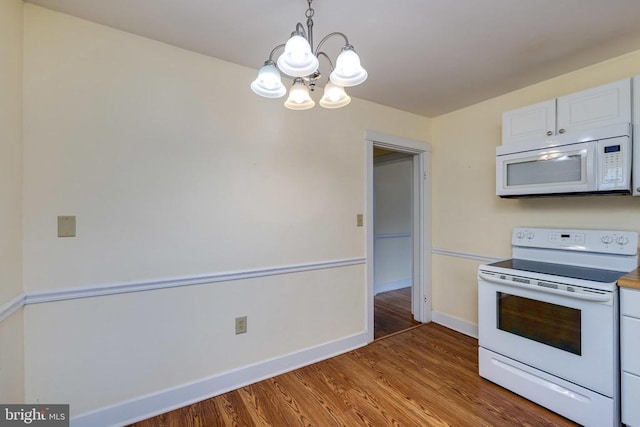 220 Mechanic St, Luray, VA 22835 - kitchen with white appliances, a chandelier, wood finished floors, baseboards, and white cabinets